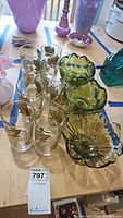 Overview of all glasses and three decorative pedestal bowls on table