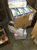 Boxes of Frank and Microflex gloves stacked showing different types and sizes.