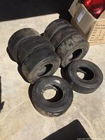 Eight go kart tires shown in two groups with six newer and two used tires visible. Tires are size 11x4.00-5NHS and have smooth slick surfaces.