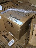 Three closed cardboard cases containing hand sanitizer bottles, stacked with visible shipping labels and handling instructions.