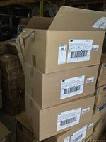 Overview photo of open cardboard case containing 3M N95 boxes stacked, showing shipping labels and case packaging.