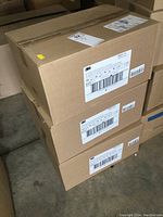 Three stacked sealed cardboard cases with 3M label for N95 1860 respirators.