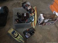 Overview of lot items including boats, controllers, and diecast cars