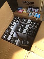 Large box with multiple Moustache brand toner cartridge boxes MTB-TN760 and smaller printer ink boxes in different colors