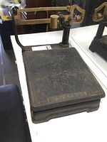 Photo showing full view of the cast iron weighing platform with Fairbanks branding.