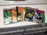Six different Marvel and DC comic books fanned out, including Hulk, Batman, Superman and Fantastic Four.