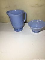 Photo showing both the Delphite Pyrex cream pitcher and sugar bowl together on a white surface.