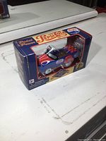 Image of the new in box die cast Pepsi pedal car miniature, showing front and side packaging and item details.