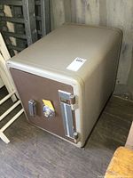 Front and top view of vintage fire safe showing condition and combination lock.