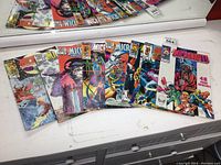 Eight different The Micronauts comic books displayed on a white surface with visible colorful covers showing characters in action poses and sci-fi settings.