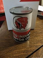 Front view of new McColl-Frontenac Red Indian Motor Oil can with Native American head logo and bold red, white, and black design.