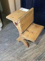 Side angled view of solid wood 2-level child's seat/plant stand, showing wood texture and structure