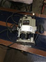 Top angled view of the Porter Cable plunge router showing the motor housing, handles, and power cord.