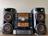 Main unit with CD changer, iPod dock and controls centered between two speakers