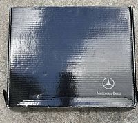 Closed Mercedes-Benz black glossy cardboard box with logo visible