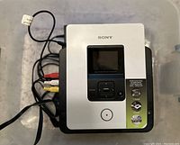 Sony DVD recorder with composite AV cables connected, top view showing front control panel, screen, and original stickers.