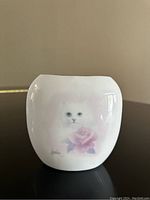 Front view showing the cat and rose painting on the white ceramic vase