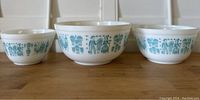 Front view of three nested bowls showing small, medium and large sizes with turquoise pattern