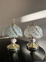 Pair of vintage twin Gurtie table lamps by Rosdorf Park with gold metal bases and floral stained glass shades