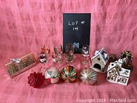 Photo showing entire collection of vintage Christmas decorations and glassware on pink fabric background