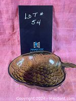 Front angle view of vintage green glass grape cluster bowl showing interior texture and stem handle