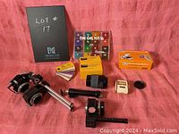 Image showing all items in the lot arranged on a pink cloth, including the slide copier, lenses, light meter, gel filter kit, and filter boxes.