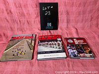 Front view of three sports books: The History of the Indy 500, Team Canada 1972, and My Greatest Day by Scott Morrison.