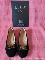 Front view of black women's slip-on shoes showing gold metallic embellishment and size 10 marking.