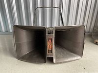 Front view of the Cobreflex speaker horn showing the dual horns and central label.