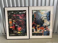 Two framed abstract art prints leaning against a wall, showing both works side by side
