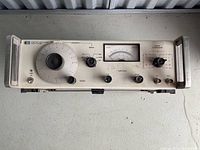 Front view of Hewlett-Packard 651B Test Oscillator showing full front panel layout with frequency dial, range selector, amplitude controls, output attenuator, and analog meter.