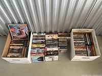 Overview of three boxes containing DVDs and one CD box set