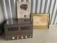 Amplifier with service sheet and chassis cover displayed together