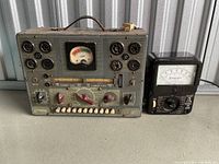 Front view of Jackson Northern Electric Tune-Tester Plus alongside Triplett analog meter unit showing front panels, dials, sockets, and meters.