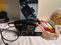 Craftsman 1 HP 3-inch belt sander showing the main body, handle, sanding belt track, and power cord