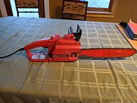 Full side view of electric Craftsman chainsaw showing body, handle, and chain bar.