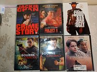 Front covers of six DVD movie cases showing titles Jackie Chan Crime Story, Jackie Chan Project A, Bourne Identity, Bourne Supremacy, The Good, The Bad and The Ugly, and Shawshank Redemption.