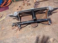 Angled view of the cast iron miter trimmer showing the black handle, miter angle guides, and rust patches around the cutting edges.