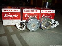 Front view of two Ledex solenoids out of three visible boxes labeled 129714-030.