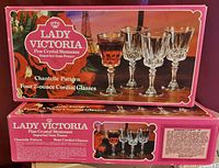 Front view of sealed pink Lady Victoria box showing 4 crystal liqueur glasses with liquid inside, Chantelle Pattern, 2 oz capacity listed