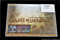 Photo shows the sealed Game of Thrones collector box with ornate design and text about included items.