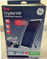 Front view of the GE Pro Crystal HD Amplified TV Antenna box showing product image, features like Pure Amp Technology, enhanced HD, Full 1080p, 4K Ultra compatibility, and coverage radius of 40 miles.