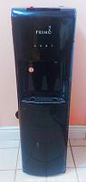 Front view of Primo water cooler and heater with glossy black finish and Primo logo.