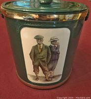 Front and side view of the green metal ice bucket with golf artwork, showing vintage golfing couple illustration and lid with golf ball knob