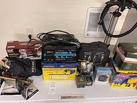 Overview of entire lot showing chargers, inflators, and accessories on table