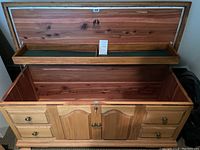 Open wooden cedar lined chest with removable felt-lined trays inside and Lane brand marking on interior lid.