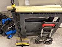 Image showing Vacmaster shop vac, two Storhorse portable sawhorses, broom and dustpan, and collapsible dolly cart.