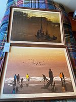 Overview of two framed Elton Bennett serigraph prints laid out side by side