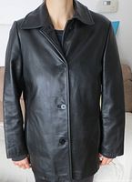 Front view of Danier black leather jacket buttoned up, showing collar, sleeves, and hem details.