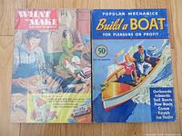 Photo showing 1951 'What to Make and How to Make It' sealed book and 1941 'Build a Boat' book covers, lying flat on a wooden floor.